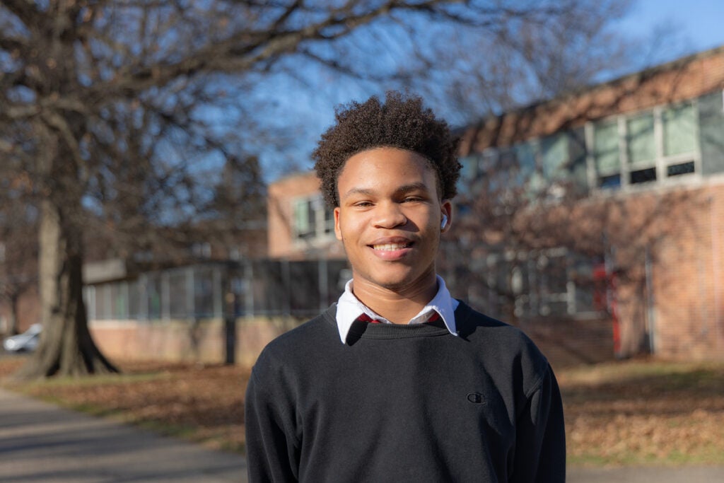 Joshua Scotland poses for a photo outside of Northeast High School