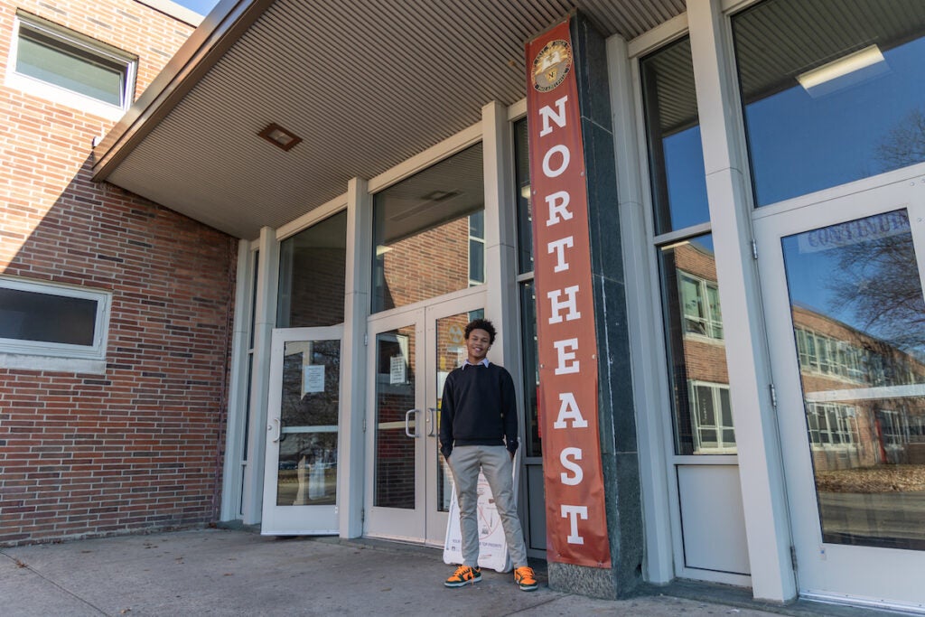 Joshua Scotland poses for a photo outside of Northeast High School