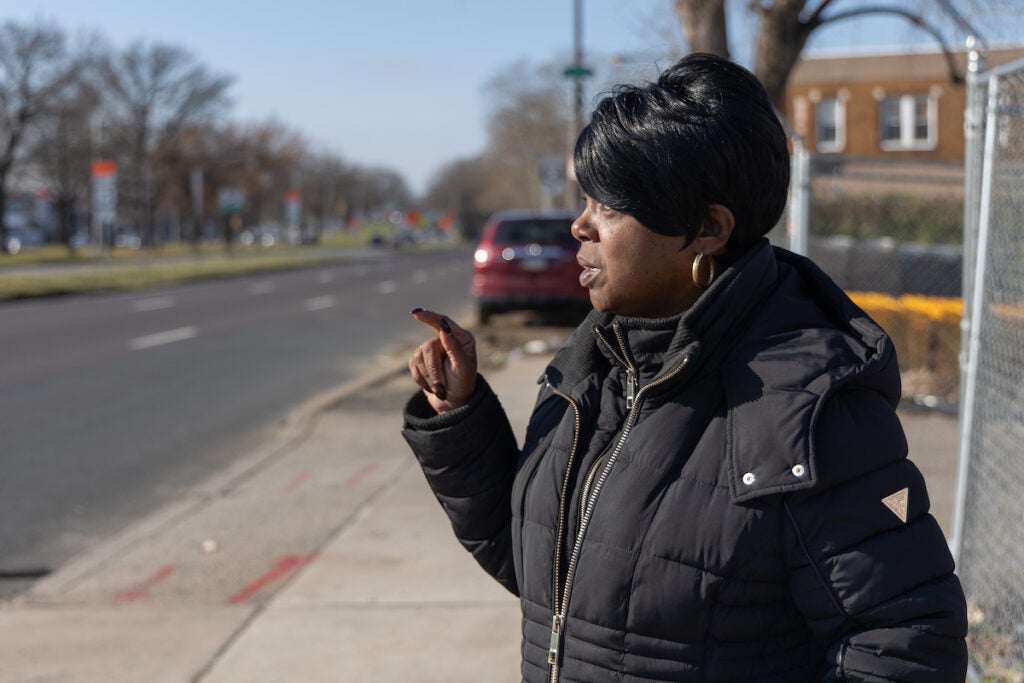 Latanya Byrd points her hand up as she looks towards Roosevelt Boulevard in front of her