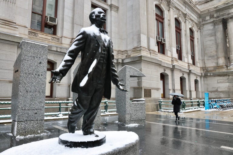 The Octavius Catto statue at Philadelphia City Hall is coated in snow and ice