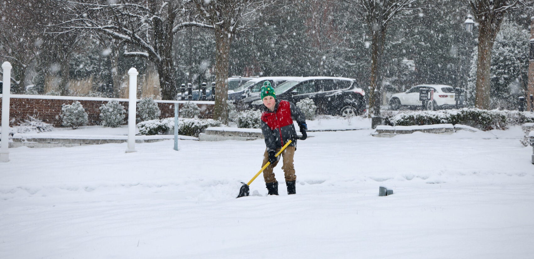 A boy shovels a walkway on Main Street in Moorestown, N.J.