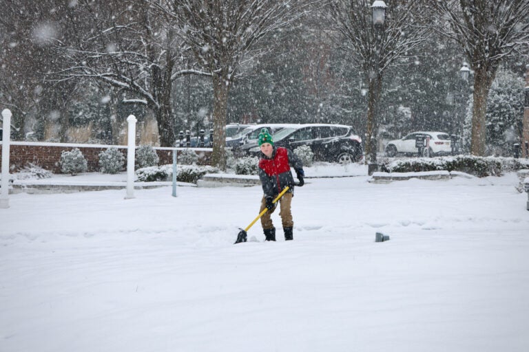 A boy shovels a walkway on Main Street in Moorestown, N.J.