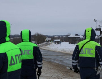 Traffic police officers block off a road near the crash site of the Russian Ilyushin Il-76 military transport plane outside the village of Yablonovo in Russia's Belgorod region on Wednesday. Stringer/Reuters