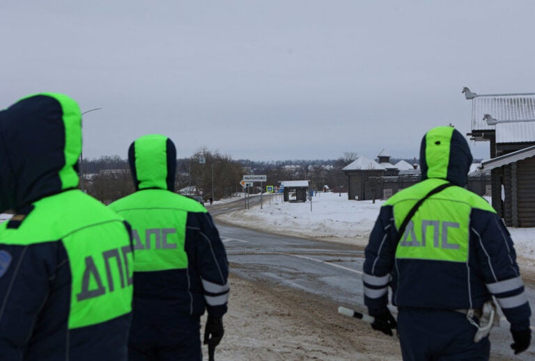 Traffic police officers block off a road near the crash site of the Russian Ilyushin Il-76 military transport plane outside the village of Yablonovo in Russia's Belgorod region on Wednesday. Stringer/Reuters