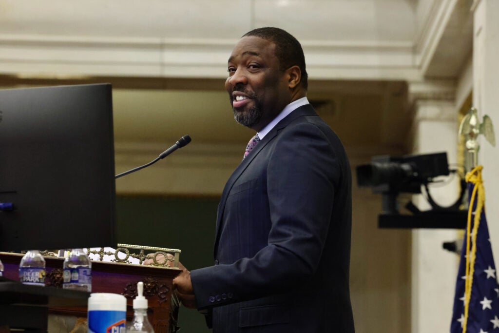 Philadelphia City Council President Kenyatta Johnson at the podium, speaking into the microphone and smiling