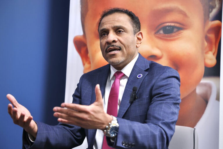 Philadelphia schools Superintendent Tony Watlington talks with WHYY education reporters in the lobby to his office at school district headquarters on North Broad Street. (Emma Lee/WHYY)