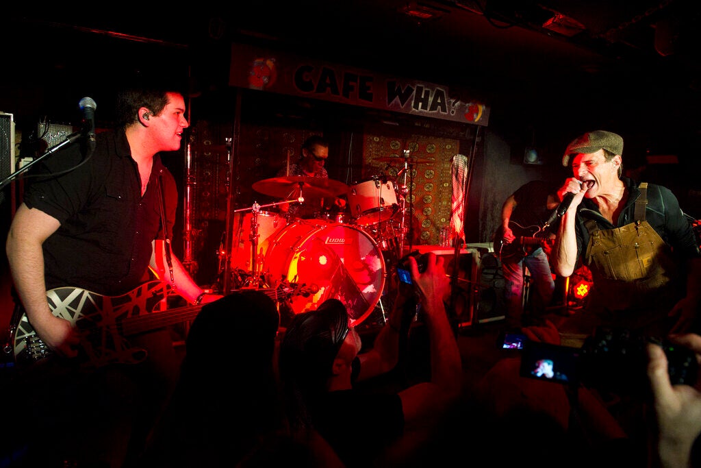 Wolfgang Van Halen, left, Alex Van Halen, and David Lee Roth perform at Cafe Wha? in New York