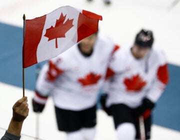 File photo: A fan waves a flag as Team Canada celebrate after the men's bronze medal hockey game against the Czech Republic at the 2018 Winter Olympics in Gangneung, South Korea, Saturday, Feb. 24, 2018