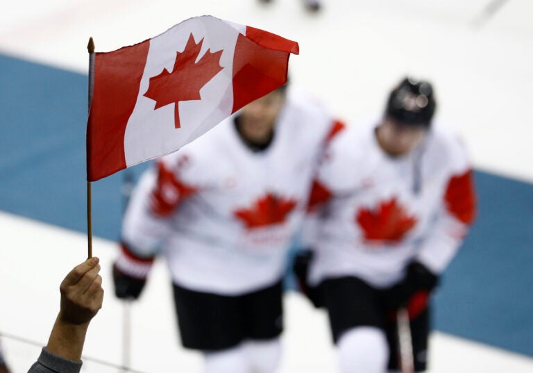 File photo: A fan waves a flag as Team Canada celebrate after the men's bronze medal hockey game against the Czech Republic at the 2018 Winter Olympics in Gangneung, South Korea, Saturday, Feb. 24, 2018