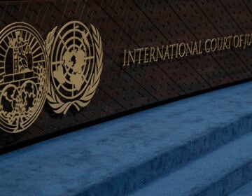 The logo of the International Court of Justice (left) and that of the U.N. (right). (AP Photo/Peter Dejong)