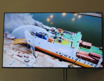 A photo displayed on a video monitor in Union,N.J., Wednesday, Jan. 10, 2024 shows a burning cargo ship in Newark N.J. on July 5, 2023.