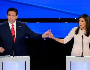 Former UN Ambassador Nikki Haley (right) and Florida Gov. Ron DeSantis (left) pointing at each other during the CNN Republican presidential debate at Drake University in Des Moines, Iowa, Wednesday, Jan. 10, 2024.