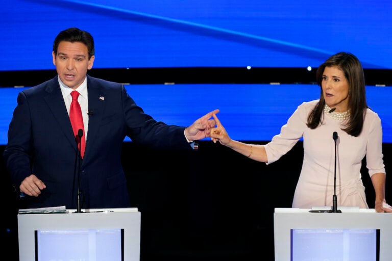 Former UN Ambassador Nikki Haley (right) and Florida Gov. Ron DeSantis (left) pointing at each other during the CNN Republican presidential debate at Drake University in Des Moines, Iowa, Wednesday, Jan. 10, 2024.