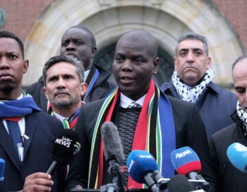 South Africa's Minister of Justice and Correctional Services Ronald Lamola (center) and Palestinian assistant Minister of Multilateral Affairs Ammar Hijazi (right) address the media outside the International Court of Justice in The Hague, Netherlands, Thursday, Jan. 11, 2024.