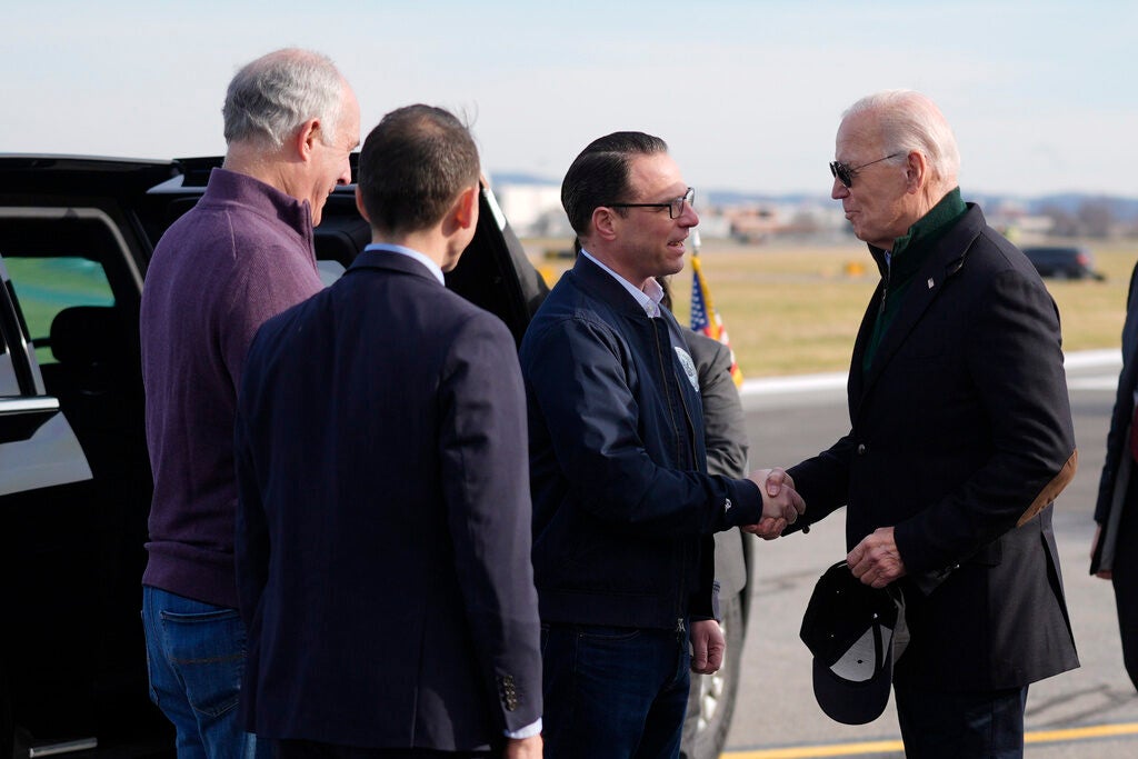 President Joe Biden arrives at Lehigh Valley International Airport, right, and greets Pa. Gov. Josh Shapiro, left, and other supporters.