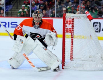 Philadelphia Flyers goaltender Carter Hart watches the puck during the third period of the team's NHL hockey game against the Minnesota Wild on Friday, Jan. 12, 2024, in St. Paul, Minn.