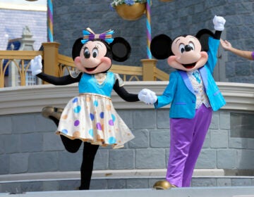 File photo: Minnie and Mickey Mouse perform for guests during a musical show in the Magic Kingdom at Walt Disney World, July 14, 2023, in Lake Buena Vista, Fla. Disney has requested a second court delay in its legal battle with Florida Gov. Ron DeSantis’ appointees over who controls Walt Disney World’s governing district. The request this week comes as the company is accusing the appointees and the governor’s office of failing to produce documents it had requested as part of the litigation. (AP Photo/John Raoux, File)