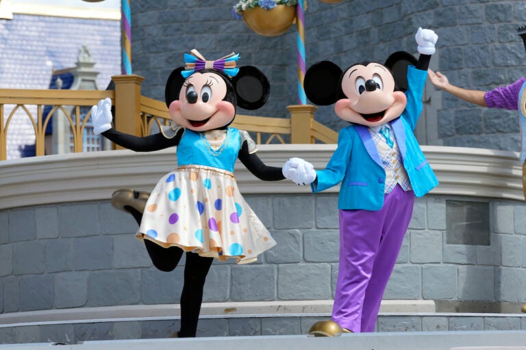 File photo: Minnie and Mickey Mouse perform for guests during a musical show in the Magic Kingdom at Walt Disney World, July 14, 2023, in Lake Buena Vista, Fla. Disney has requested a second court delay in its legal battle with Florida Gov. Ron DeSantis’ appointees over who controls Walt Disney World’s governing district. The request this week comes as the company is accusing the appointees and the governor’s office of failing to produce documents it had requested as part of the litigation. (AP Photo/John Raoux, File)