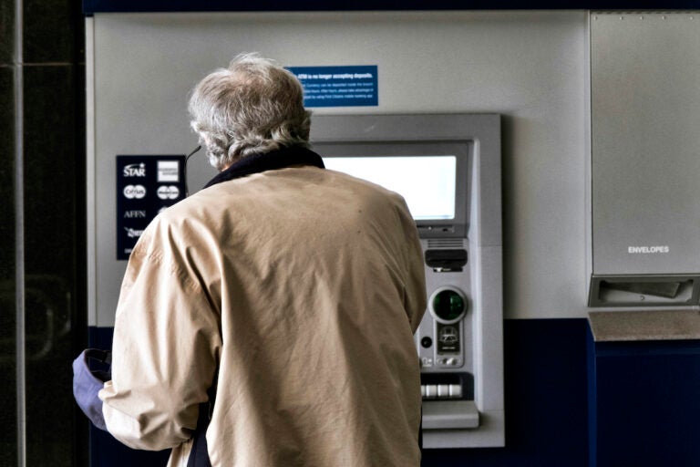 File photo: A customer makes a transaction at an automatic teller machine in Los Angeles on March 27, 2023.