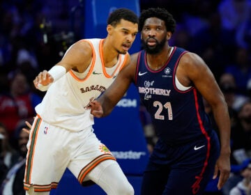 San Antonio Spurs' Victor Wembanyama (left) and Philadelphia 76ers' Joel Embiid struggle for position during the first half of an NBA basketball game, Monday, Jan. 22, 2024, in Philadelphia. (AP Photo/Matt Slocum)