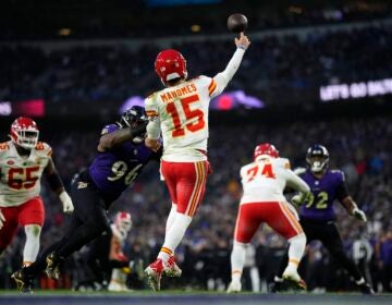 Kansas City Chiefs quarterback Patrick Mahomes (15) passes under pressure from Baltimore Ravens defensive tackle Broderick Washington (96) during the second half of the AFC Championship NFL football game, Sunday, Jan. 28, 2024, in Baltimore.