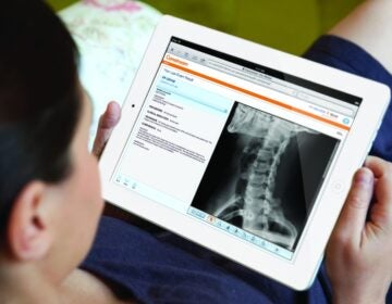 Woman shopping at online Sainsbury's store using an iPad tablet computer