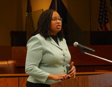 Dr. Monica Taylor speaking at a podium