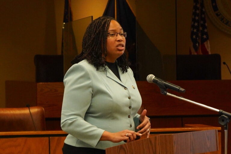 Dr. Monica Taylor speaking at a podium