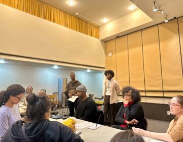 Attendees are locked in during the 15-minute discussion portion of WHYY's Building Blocks event on youth homelessness, hosted by manager of community engagement Eric Marsh Sr. and moderated by reporter Kenny Cooper.