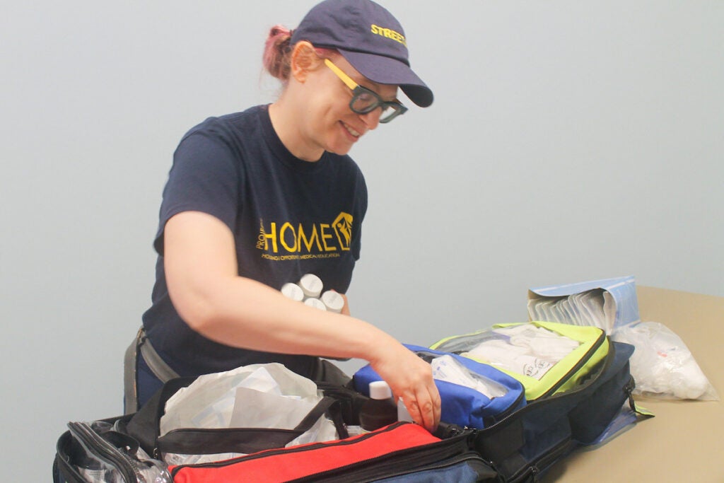 Kara Cohen packs a bag filled with medical supplies