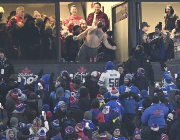A shirtless Jason Kelce roars out of a club box in Buffalo while watching his brother Travis and the Chiefs eek out a win over the Bills. (Courtesy NFL/Twitter.com)