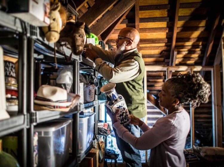 Senior couple organizing items in the home attic