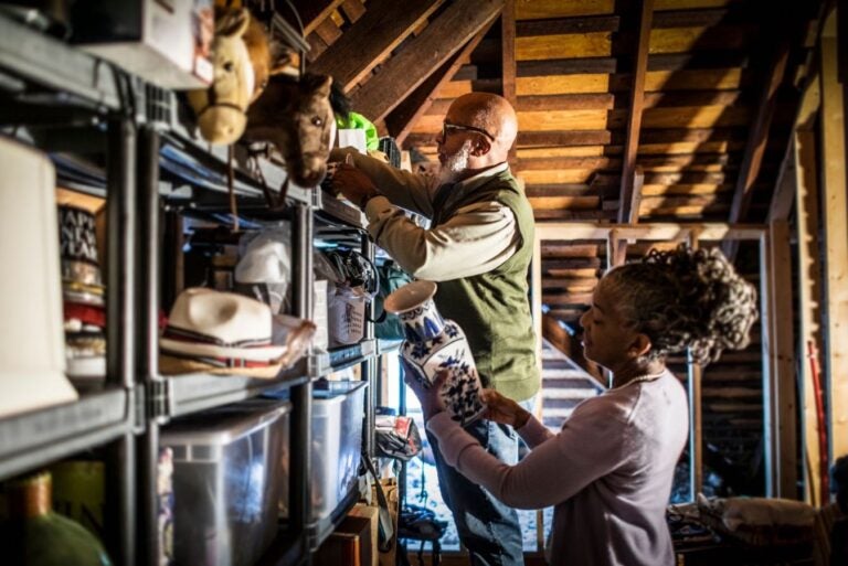 Senior couple organizing items in the home attic