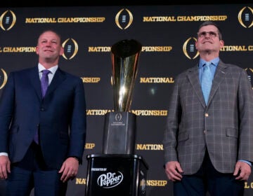Washington head coach Kalen DeBoer, left, and Michigan head coach Jim Harbaugh pose with the trophy after a news conference ahead of the national championship NCAA College Football Playoff game between Washington and Michigan on Sunday, Jan. 7, 2024, in Houston. The game will be played Monday.
(Godofredo A. Vasquez/AP)