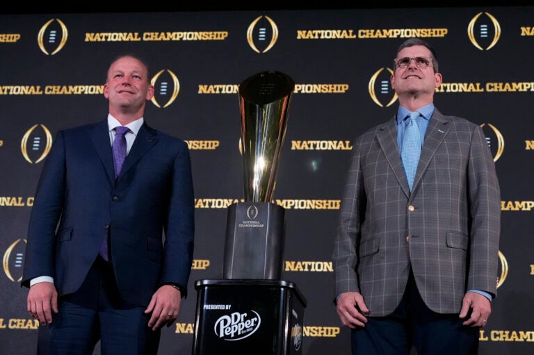 Washington head coach Kalen DeBoer, left, and Michigan head coach Jim Harbaugh pose with the trophy after a news conference ahead of the national championship NCAA College Football Playoff game between Washington and Michigan on Sunday, Jan. 7, 2024, in Houston. The game will be played Monday.
(Godofredo A. Vasquez/AP)