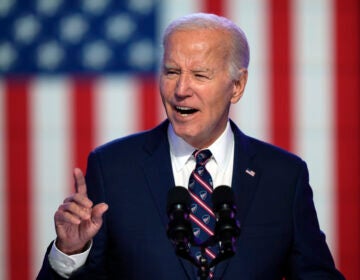 Biden speaking in front of the backdrop of a U.S. flag