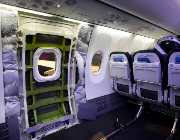 The door plug area of an Alaska Airlines Boeing 737 Max 9 aircraft, seen with the paneling removed, awaits inspection