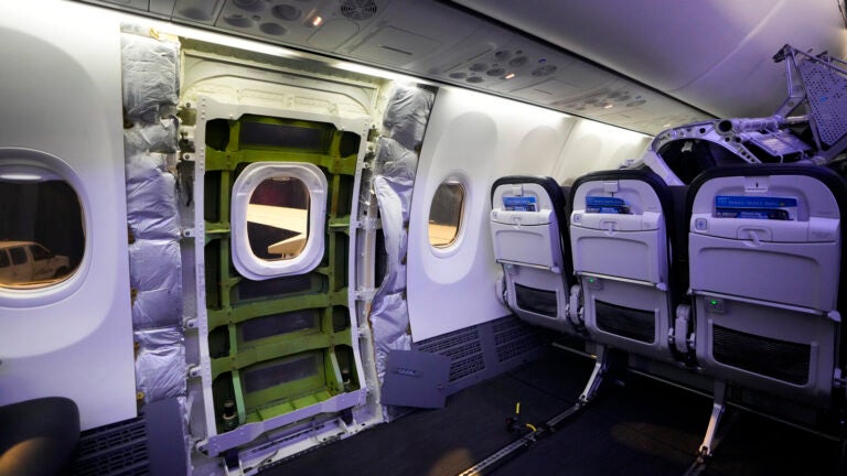 The door plug area of an Alaska Airlines Boeing 737 Max 9 aircraft, seen with the paneling removed, awaits inspection