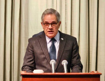 Larry Krasner speaking at a podium