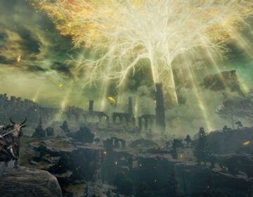 A rider looks at a landscape with stone towers that reach into the sky, with a giant yellow glowing tree at the center.