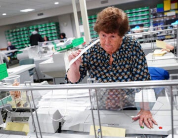 woman at ballot processing center