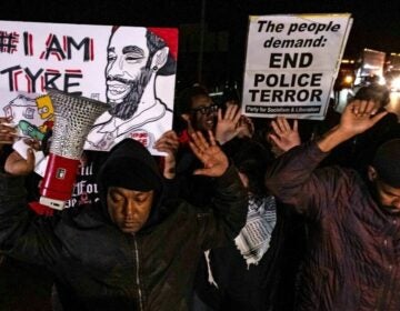 Protesters holding signs that read I am Tyre and End Police Terror.