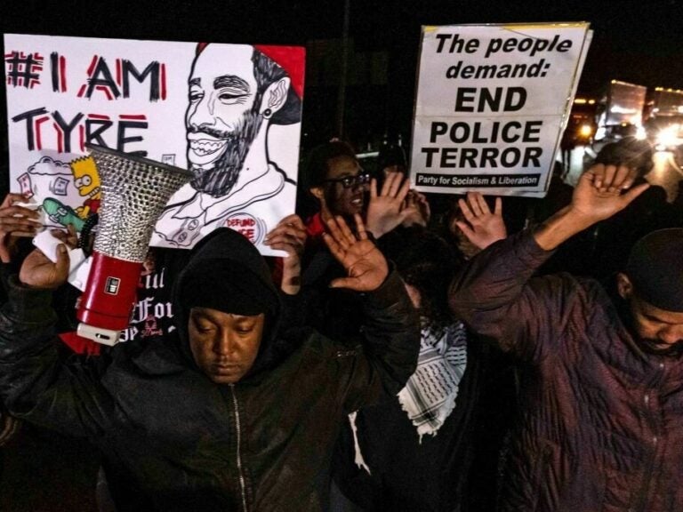 Protesters holding signs that read I am Tyre and End Police Terror.