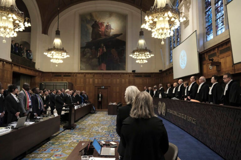 Judges and parties stand up during a hearing at the International Court of Justice in The Hague