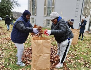 Nanette Daniels (right) and her aunt, Joanna Brown, bag leaves during a Martin Luther King Day of Service event at Sweetbriar Mansion in West Fairmount Park.