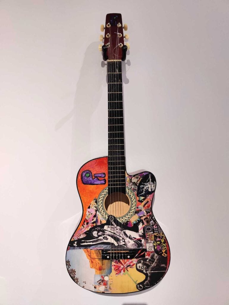 A collage and artwork on a guitar