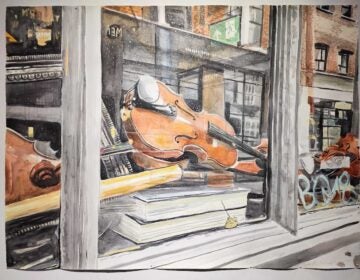 A painting of a violin visible in a window