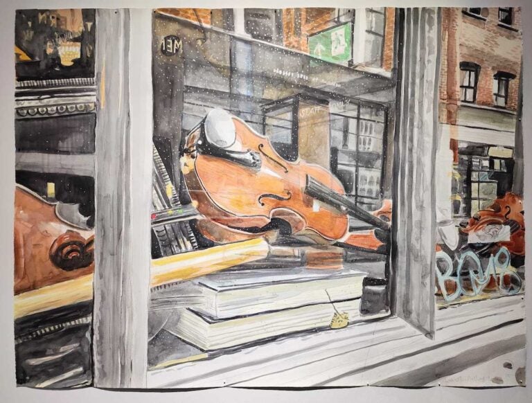 A painting of a violin visible in a window