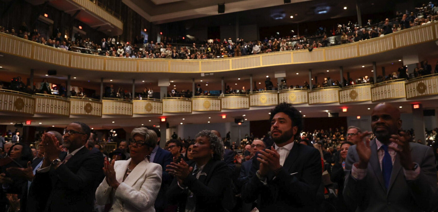 Audience members giving a standing ovation