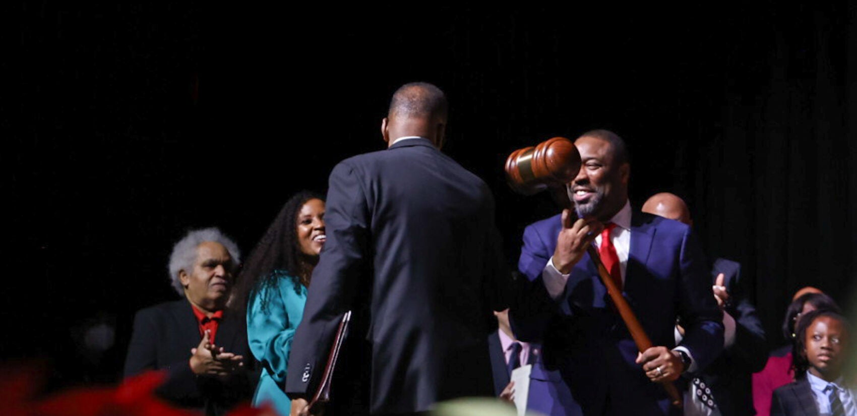 Darrell Clarke hands a large gavel to Kenyatta Johnson